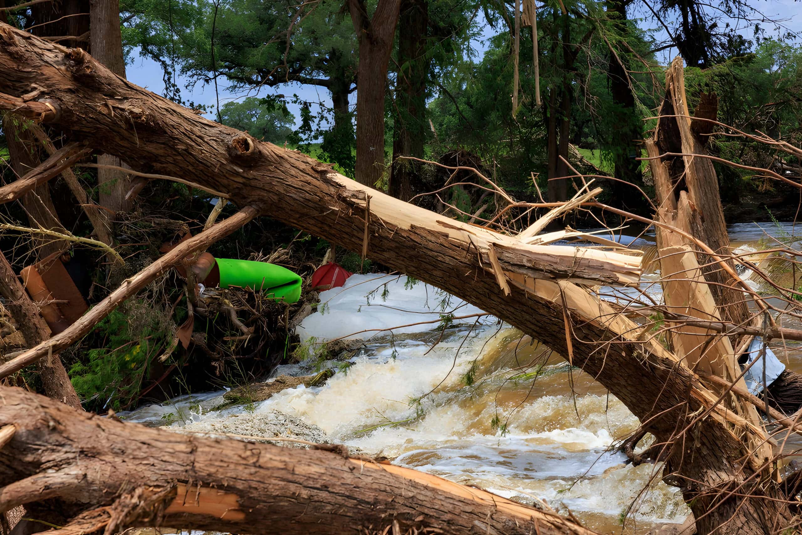flash-flood-damage-broken-trees-debris-river
